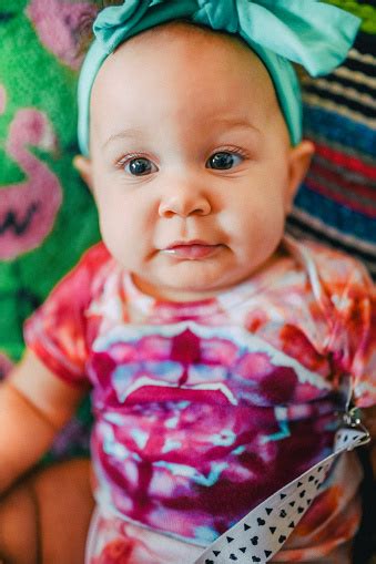 Adorable 6 Month Old Mixed Race Baby With Curly Hair In An Indoor