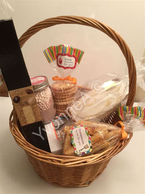 A Wicker Basket Filled With Cookies And Snacks On Top Of A White Table