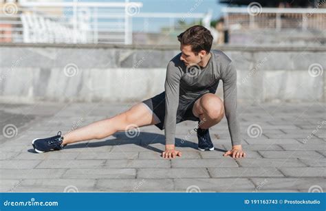Healthy Lifestyle Warm Up And Jogging Guy Doing Exercises Before