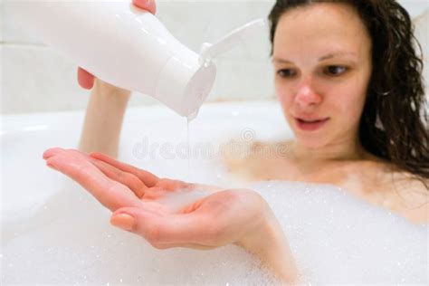 Brunette Woman Pouring Shampoo On Hand In Shower Stock Photo Image Of