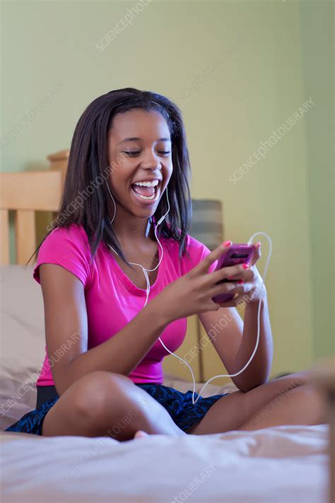 teenage girl listening to headphones stock image f005 2667 science photo library