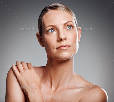 Beautiful Mature Woman Posing In Studio Against A Grey Background Stock