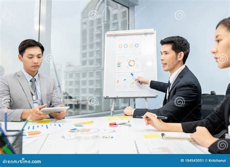 Asian Businessman Presenting Business Plan Charts At The Meeting Stock