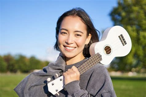 Portrait Of Beautiful Smiling Girl With Ukulele Asian Woman With