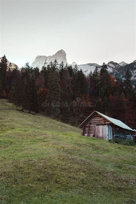 A Mountain Wooden Hut In The Forest With High Mountains Stock Image