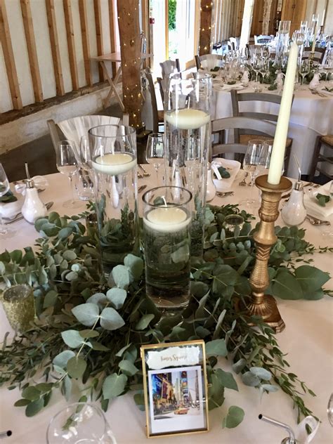 Our Mixed Height Cylinder Vases With Floating Candles Surround By Lots