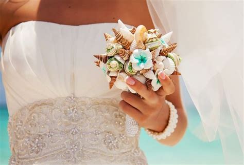 Beach weddings will fit every budget: beach wedding bouquet idea seashells plumeria flowers ...