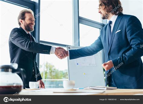 Businessmen Shaking Hands — Stock Photo © Arturverkhovetskiy 166638142