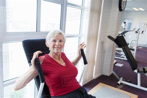 Older Woman Exercising In Gym Stock Photo Dissolve