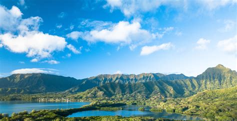 Green Forested Mountain Range Under Blue Sky With Clouds · Free Stock Photo