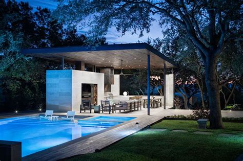 This Poolside Living Room And Kitchen Sits Under A Large Floating Canopy Modern Pool House