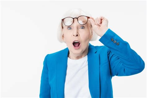 Premium Photo Surprised Senior Woman Looking Through Her Eyeglasses Isolated On White Background