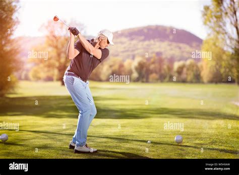 Old Man Swinging Golf Club Stock Photo Alamy