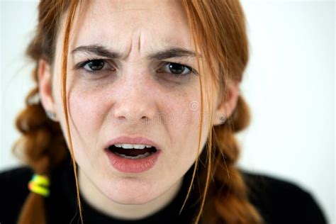 Angry Redhead Young Woman Posing With A Medical Face Mask Stock Photo