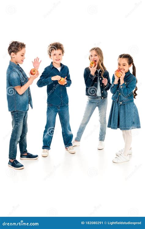 Full Length View Of Children In Denim Clothes Eating Apples On White