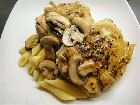 Chicken With Mushrooms Garlic And Onion In A White Wine Sauce Over