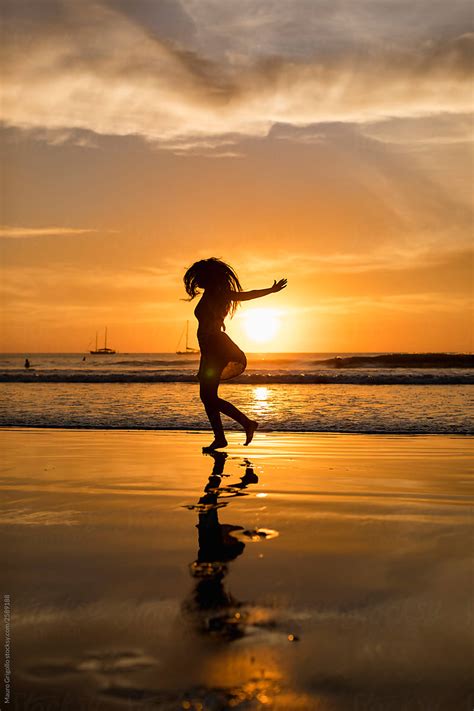 Girl Dancing On The Beach At Sunset Del Colaborador De Stocksy Mauro Grigollo Stocksy