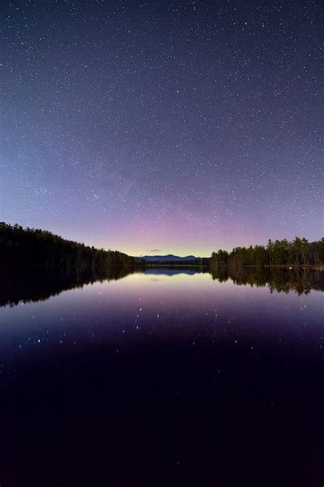 Lake View Under Clear Blue Night Sky During Night Time · Free Stock Photo