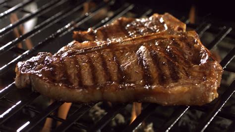 Getting a perfectly grilled steak is trickier than you might think, though. T-bone Steak On Barbecue Grill Stock Footage Video 4556759 | Shutterstock