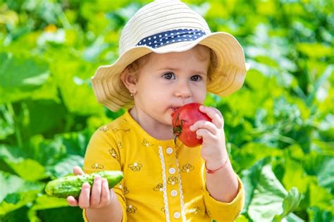 Premium Photo Child In The Vegetable Garden Selective Focus
