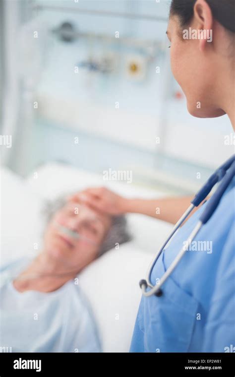 Nurse Looking At A Patient While Touching Her Stock Photo Alamy