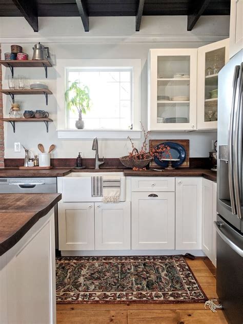 White kitchen cabinets with black slate appliances. Modern Farmhouse Kitchen | White shaker kitchen cabinets ...