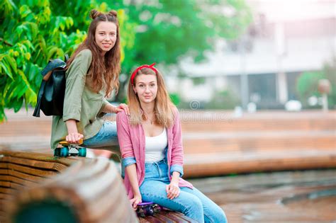 Two Happy Girls With Skateboards Outdoors Active Sporty Women Having