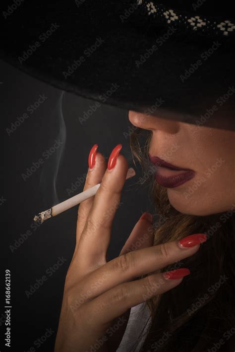 Portrait Of Sexy Elegant Lady Woman With Hat Smoking Cigarette Stock