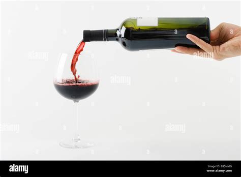 Hand Pouring Red Wine Into Glass Stock Photo Alamy