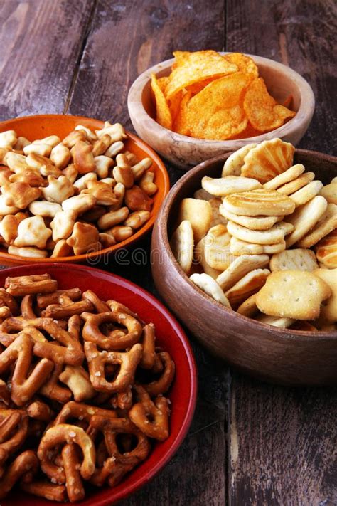 Salty Snacks Pretzels Chips Crackers In Wooden Bowls Stock Image