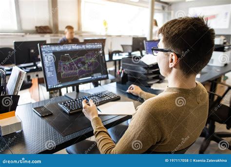Engineer Designer Working On Desktop Computer In Factory Stock Photo