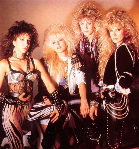 Four Women Dressed In Punk Clothing Posing For A Photo Together With One Woman Holding Her Hand
