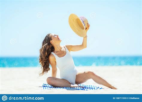 Cheerful Woman Sitting On Striped Towel On Seacoast Stock Image Image Of Solo Fitness
