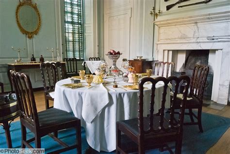 1700s Style Place Settings And Furniture Gather Around A Dining Table