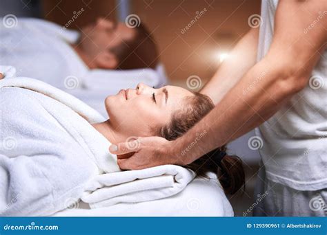 Beautiful Young Woman Receiving Massage On Head And Shoulders Zone In Spa Centre Stock Image