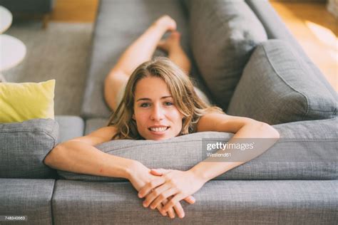 Portrait Of Young Woman Relaxing On Couch At Home Photo Getty Images