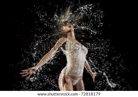 Girl In A Spray Of Water On A Black Background Stock Photo 72818179