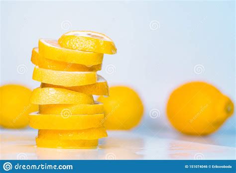 Three Whole Lemon And Pile Of Slices On Light Background Close Up View
