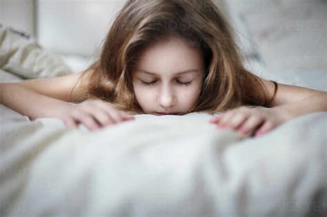Caucasian Teenage Girl Laying On Bed Stock Photo