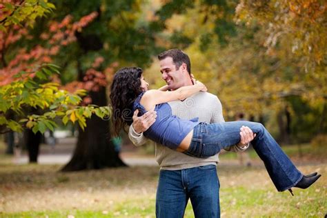 Woman In Man S Arms A Man Holding A Woman In His Arms In The Park Sponsored Advertisement
