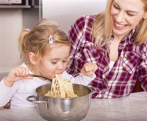 Madre Feliz Con Su Hija Comiendo Espaguetis Caseros En La Encimera De