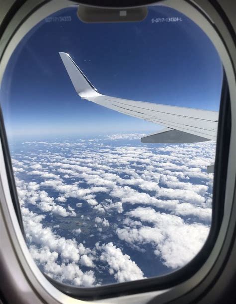 view of the clouds from plane window on a sunny day🌤 travel clouds airplane view plane