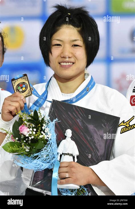 japan s misato nakamura poses with her gold medal for the women s 52 kilogram event during an