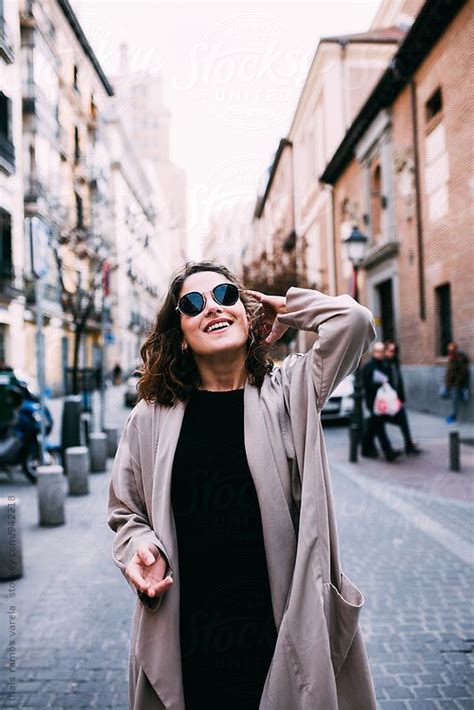 view woman wearing sunglasses and smiling by stocksy contributor thais varela