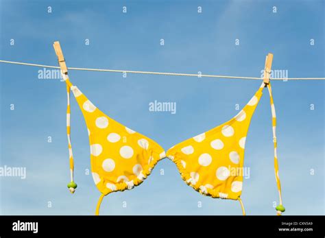 An Itsy Bitsy Teeny Weeny Yellow Polka Dot Bikini Hanging On A Clothesline With Copy Space Stock