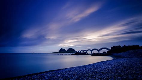 Download Wallpaper 3840x2160 Sea Coast Stones Bridge Sunset