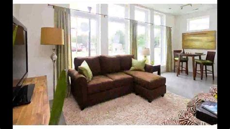 This more eclectic styled living room features dark wood floors with little variation in tone, which allows patterns in the furniture to be more varied and still not compete. Brown Couch Living Room Design - Photos Nice - YouTube