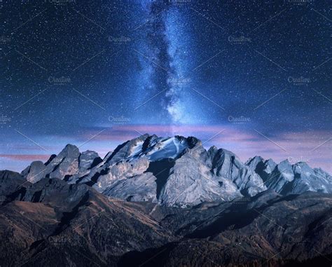 The Night Sky Is Filled With Stars Above Mountains