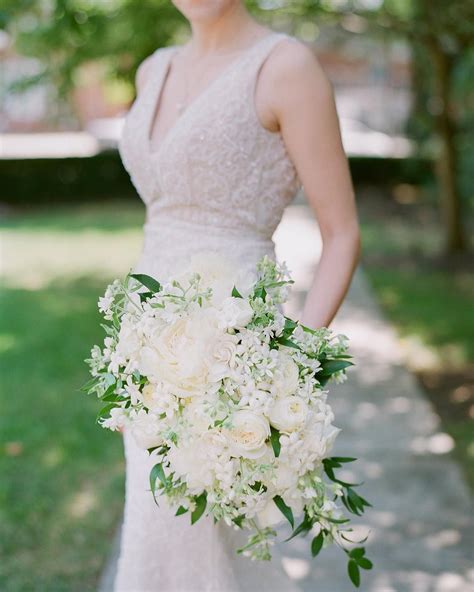 All white bridal bouquet created with white ranunculus, white stephanotis, white tweedia, whit 