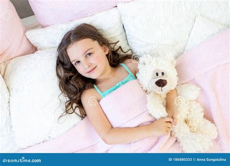 A Charming Little Girl Of 5 6 Years Old Hugs A Teddy Bear Cute Child